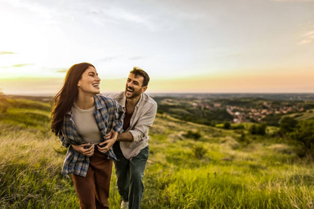 istock Happy young couple having fun dating in nature 2198735475