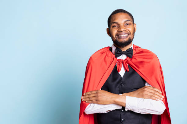 istock Smiling hotel concierge staff in a red cape poses as a superhero 2198737222