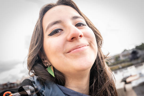 Young woman laughing, with tears from eyes