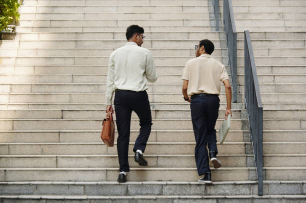 istock Colleagues Going Up The Stairs Outdoors 2198739203