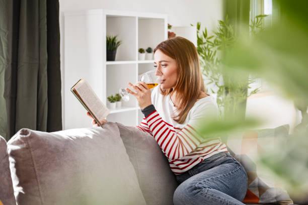istock Woman Enjoying a Novel with Wine 2198739995