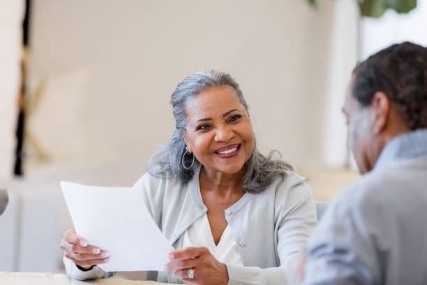 istock Happy Mature Couple Discussing Finances Together at Home 2198740626