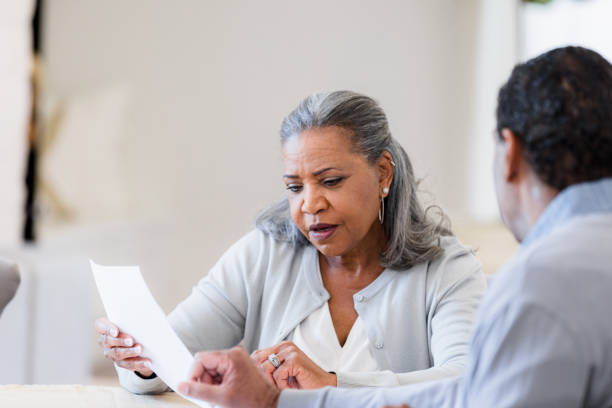 istock Mature Couple Reviewing Documents Together at Home 2198740627