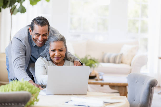 istock Happy Senior Couple Using Laptop Together at Home 2198740635