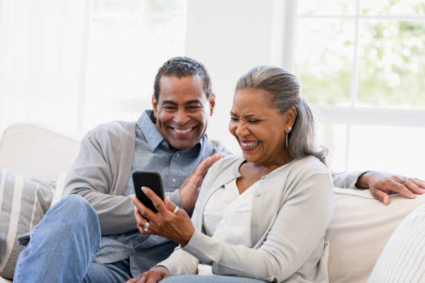 istock Happy Mature Couple Using Smartphone Together at Home 2198740638