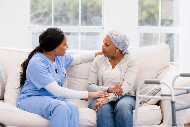 istock Nurse providing emotional support to a senior patient at home 2198740672