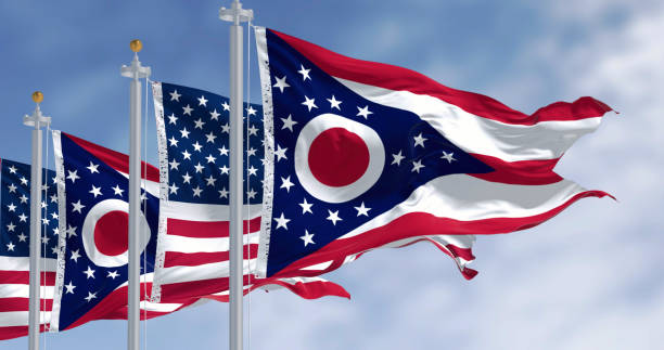 istock Ohio and national US flags waving in the wind on a clear day 2198741124