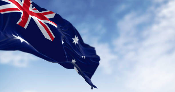 istock Australia national flag waving in the wind on a clear day 2198741185