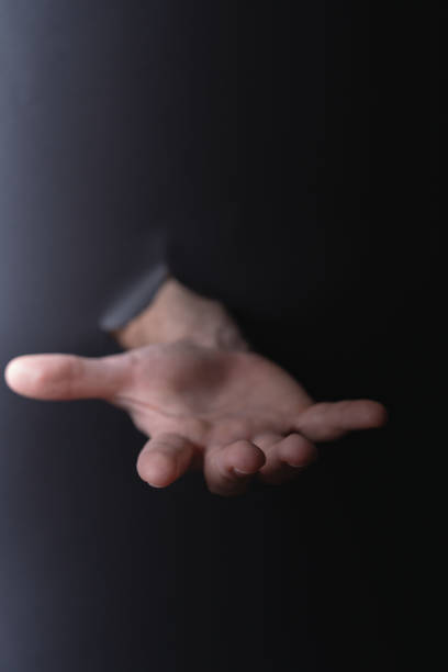 photo Dramatic Expression of Open Hand in the Dark Captures Attention with Its Symbolic Invitation and Unique Minimalist Aesthetic
