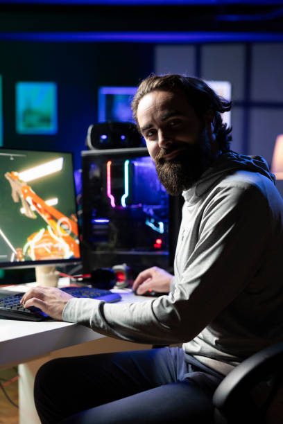 istock Close up of cheerful gamer streaming game in neon lit studio 2198742144