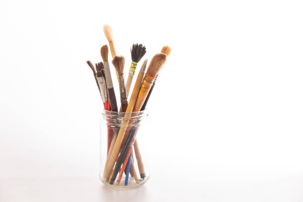 istock Artistic paintbrushes arranged in a glass jar on a bright surface during daylight hours, representing creativity in a studio environment 2198743110
