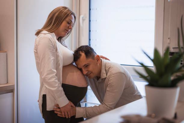 istock Man leaning his head on wife pregnancy bump 2198743824