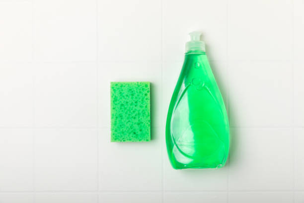 Colorful dish sponges on background. Kitchen sponge. Cleaning concept, cleaning service. Dishwashing liquid with clean and dirty dishes plate. Place for text, copy space. Wash the dishes.