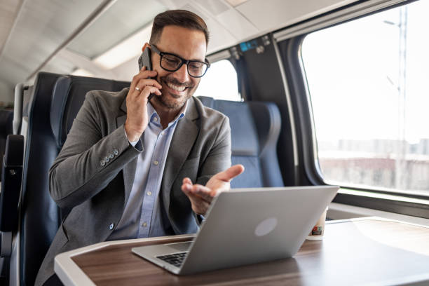istock On-the-go businessman: working and talking business in the train 2198744111