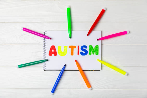 istock Autism awareness day.2 April world autism awareness day background.Design element.Care Awareness campaign for Autism.AUTISM text with colorful wooden puzzles, letters and cubes.Space for text.Top view 2198744396