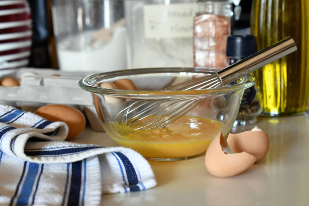 A bowl with whisked beaten eggs in it in a kitchen setting