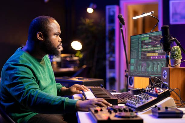 istock Music engineer producing a song by mixing and mastering tunes on audio console 2198746013