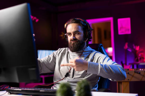 istock Gamer showing middle finger to opponents to make viewers laugh during stream 2198747005