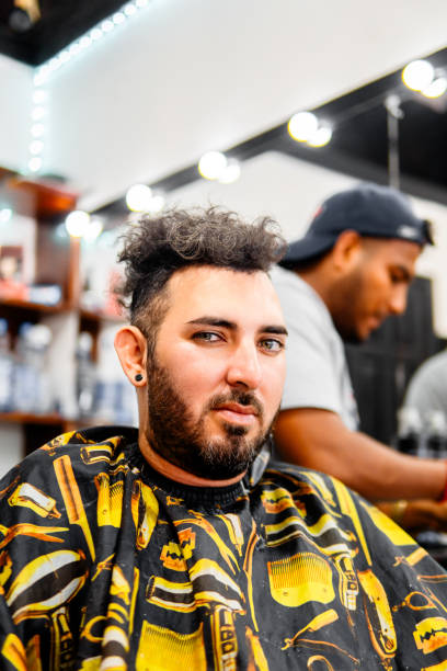 istock Hispanic man getting a haircut in a barbershop 2198747269