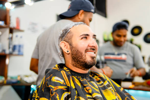 istock Hispanic man smiling while getting hair washed at barbershop 2198747342