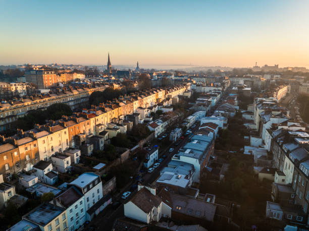 Aerial view of bristol's colorful houses and streets glowing during sunrise, showcasing the city's architectural beauty