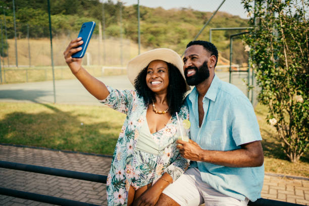 istock Couple drinking and making selfie near the hotel pool 2198750324
