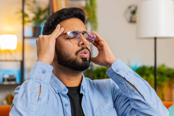 istock Sick Indian man rubbing temples to cure headache problem, suffering from tension migraine stress 2198750743