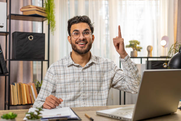 istock Indian freelancer prepares startup project for presentation finds idea using laptop at home office 2198751591