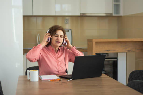 istock Senior woman working on her laptop at home 2198755575