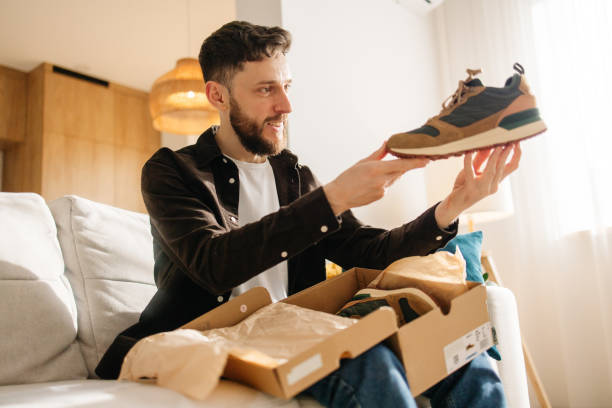 istock Satisfied Man Examining His New Sneakers from Online Order 2198756021