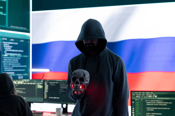 istock Conceptual image of a hooded russian hacker creating hazardous alerts 2198757529