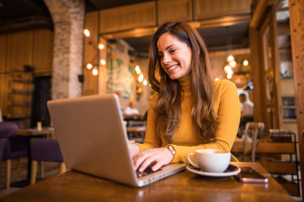 istock Woman Working In Cafe With Laptop and Coffee 2198758420