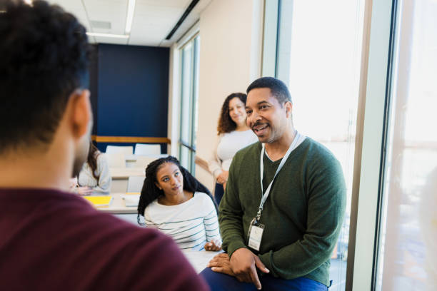 istock Professor leading discussion with diverse students in classroom 2198758853