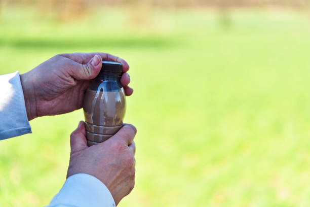 Drinking Coffee Latte from Recycled PET Plastic Bottle Outside