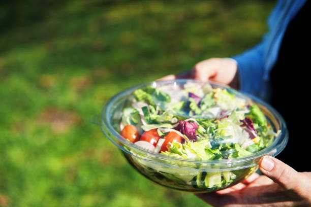 istock Eating Mixed Salad Bowl Packed in a Plastic Box Outside 2198760863