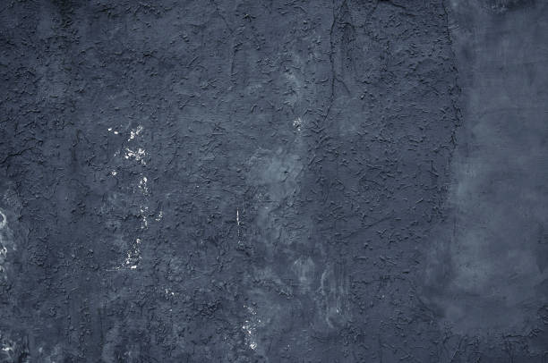 istock A dark blue wall with plaster, stains and various reliefs. 2198761219
