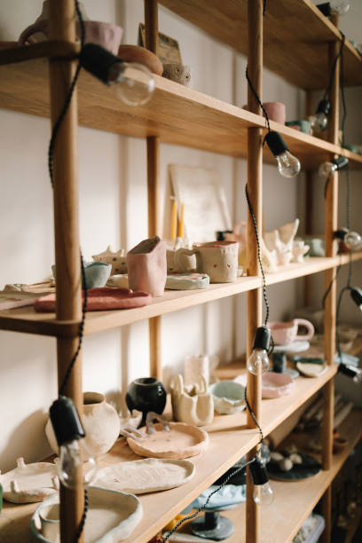 istock Shelf with handmade clay cups and plates in the pottery studio. Creating ceramics ware with own hands. 2198761302
