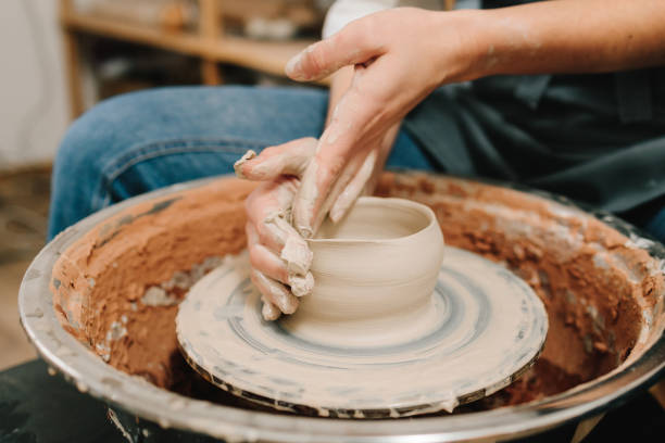 istock Potter creates a ceramic bowl in the pottery studio. Process of making a unique ceramic shape. 2198761409