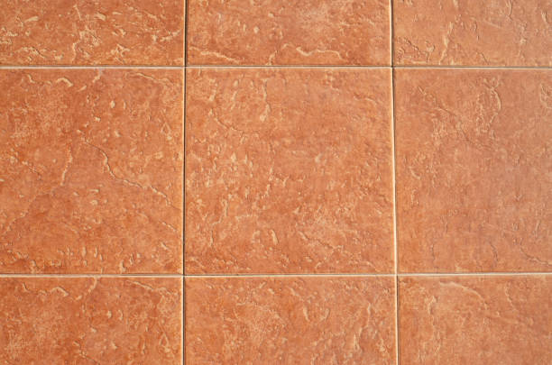 istock Orange ceramic tiles on wall closeup 2198763478