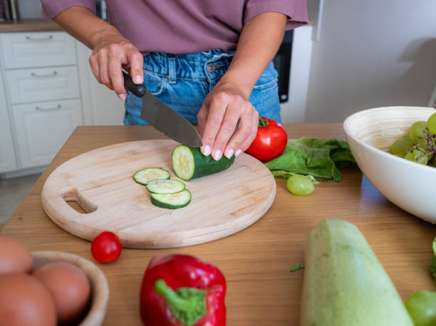 istock female hands are cutting vegetables in the kitchen 2198764002