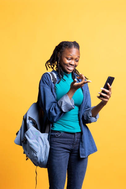 istock Teenager having fun catching up with mates during videocall, studio background 2198765602