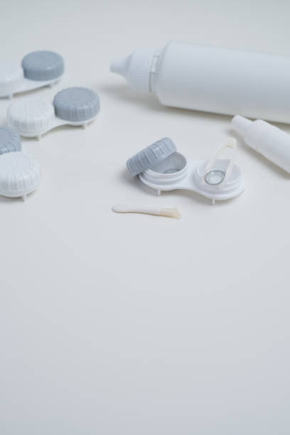 istock Contact lenses, case and bottle with solution and eye drops on white background. Eye health and care, vision, ophthalmology concept, close-up 2198765645