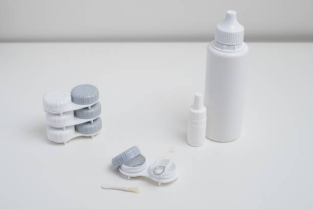 istock Contact lenses, case and bottle with solution and eye drops on white background. Eye health and care, vision, ophthalmology concept, close-up 2198765670