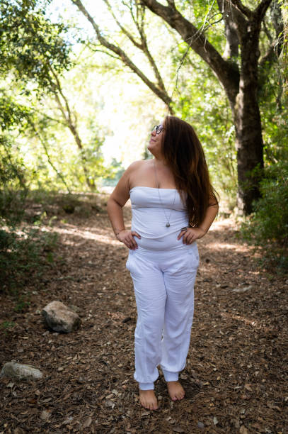 istock Young woman enjoying freedom in the forest 2198766126