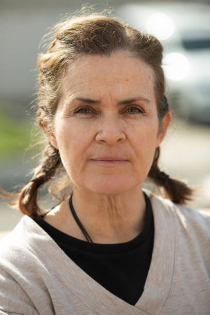 istock Serious mature woman posing in a park looking at the camera 2198768322