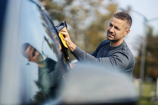 istock A young tidy man is cleaning car windows with rag at self service car wash. 2198768541