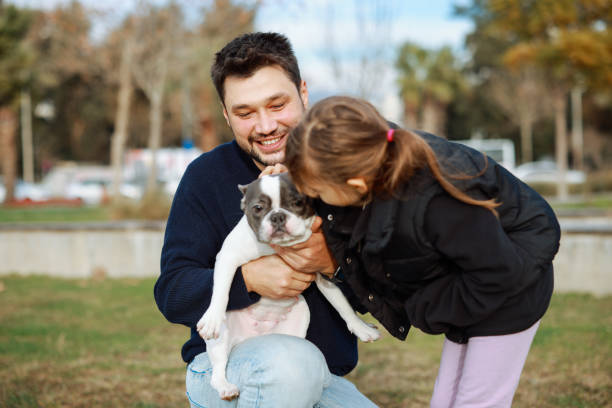 istock Young father and his daughter with a dog 2198770082