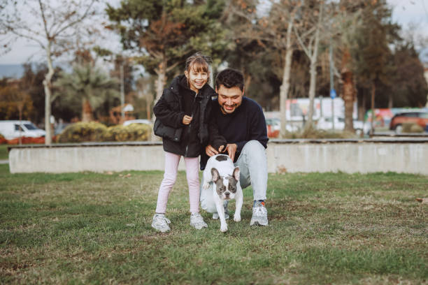 istock Young father and his daughter with a dog 2198770227