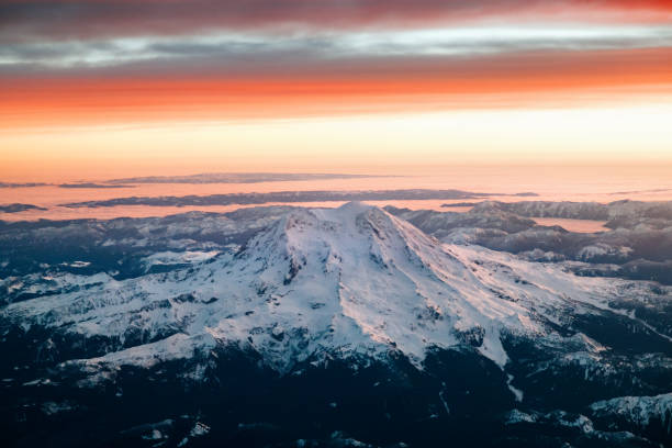 An early morning aerial view over Mt. Rainier in Washington state, USA.  Vibrant orange and pink colors.