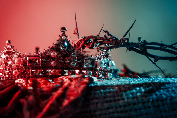 Juxtaposition of a kings crown and a crown of thorns, parallels in the Easter story of the crucifixion of Jesus Christ in the Bible.